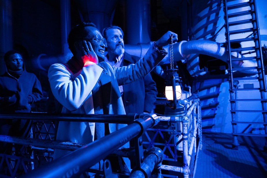 caption: Audience members watch as actors climb a ladder in the 118-year-old Georgetown Steam Plant in October 2024.