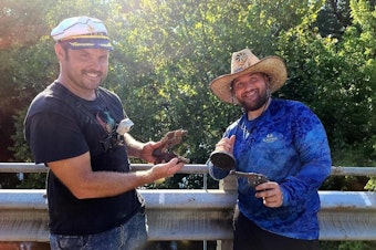 caption: Brothers Jake and Adam Cowart show off a magnet fishing haul. They are among many who picked up the hobby during the pandemic.