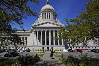 caption: A person walks near the Legislative Building, Wednesday, April 21, 2021, at the Capitol in Olympia, Wash. On Tuesday, April 2, 2024, the U.S. Supreme Court denied a request to stop implementation of a new state legislative district map from taking effect in Washington.