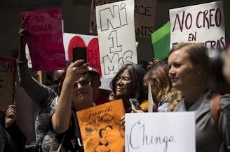 caption: A crowd gathers on Tuesday, June 26, 2018, to show support for Maru Mora-Villalpando during an ICE hearing outside of the Immigration Court building on 2nd Avenue in Seattle. 