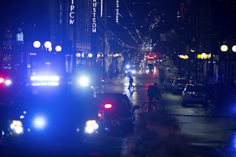 caption: Patrol cars and ambulances are shown at the intersection of Third Avenue and Pine Street on Wednesday, January 22, 2020, following a shooting that left multiple victims injured and one dead in Seattle.