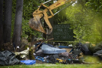 caption: The city of Seattle removed unhoused people and their belongings from an encampment on Tuesday, May 10, 2022, at Woodland Park in Seattle. The U.S. Supreme Court ruled Friday that cities can ban public sleeping and camping.