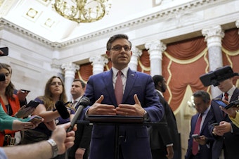 caption: Speaker of the House Mike Johnson speaks with reporters in Statuary Hall after meeting with Reps. Marjorie Taylor Greene and Thomas Massie on May 6.