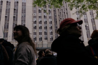 caption: A line forms Monday outside the courthouse for a chance to sit in on the 16th day of former President Trump's hush-money trial in Manhattan, N.Y.