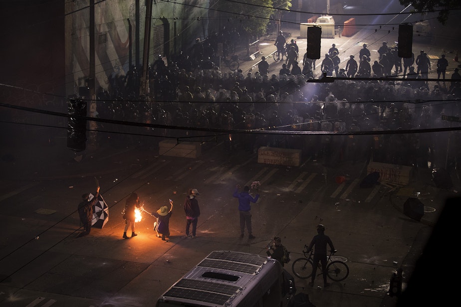 caption: The exact moment that the blast hit Aubreanna Inda, 26, at the demonstrations on Capitol Hill. Seattle police officers deployed chemical agents, pepper spray and flash-bang grenades on protesters at the intersection of 11th Avenue and East Pine Street on the 10th day of protests following the police killing of George Floyd, shortly after midnight on Monday, June 8, 2020, in Seattle.