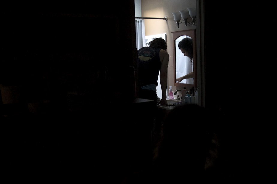 caption: Jake Black checks on his wife, Hope Black, as she labors in the bathtub at 5:27 a.m., on Friday, May 28, 2020, at their home on Vashon Island. 