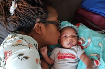 caption: Dr. Alisha Liggett with her son as a newborn. Liggett, who grew up in Seattle and attended Garfield High School, is a doctor in New York.