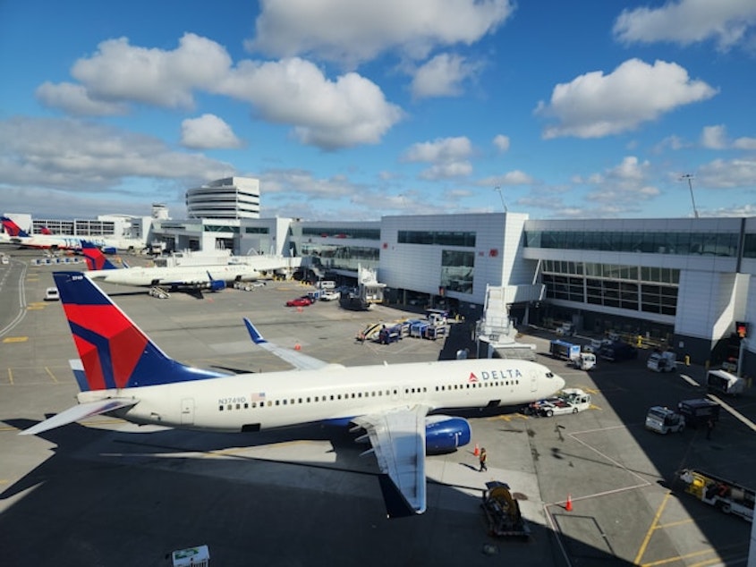 caption: A Delta airplane at a gate at SeaTac International Airport on May 15, 2024.