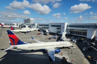 caption: A Delta airplane at a gate at SeaTac International Airport on May 15, 2024.