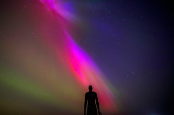 caption: Crosby Beach, Liverpool, England: The aurora borealis, also known as the northern lights, glow on the horizon at Another Place by Anthony Gormley.