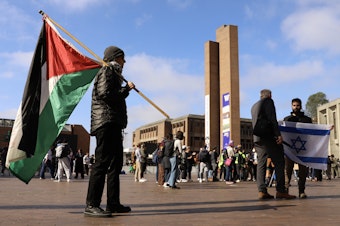 caption: Palestinian and Israeli flags during a protest at UW Red Square. Seattle, Oct. 12, 2023