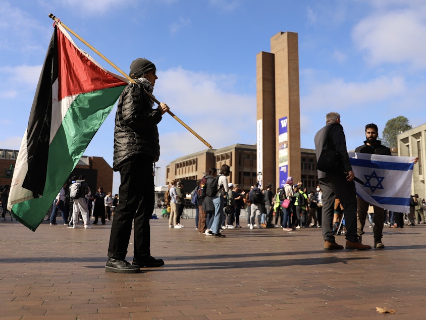 caption: Palestinian and Israeli flags during a protest at UW Red Square. Seattle, Oct. 12, 2023