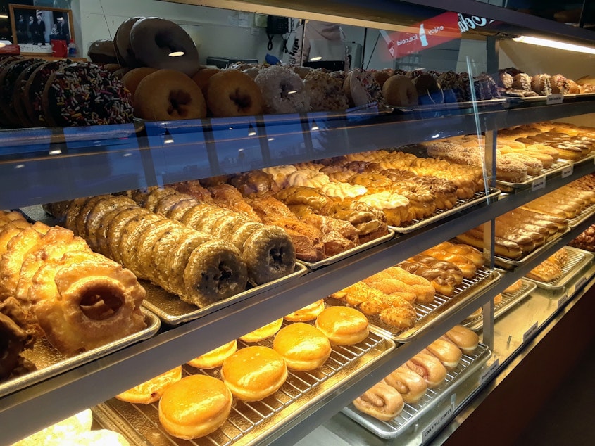 caption: Rows of freshly made donuts on a cold, early morning at Dockside Donuts in Tacoma.