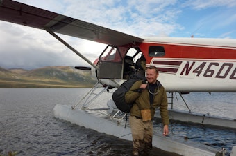 caption: Host Chris Morgan being picked up by float plane in an incredibly isolated area of the Brooks Range in northern Alaska.