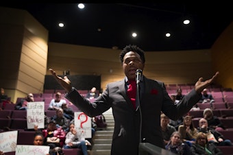 caption: Kevin Amos addresses Seattle Public Schools leadership about teacher misconduct issues during a public meeting on Thursday, February 13, 2020 at Garfield High School in Seattle. 