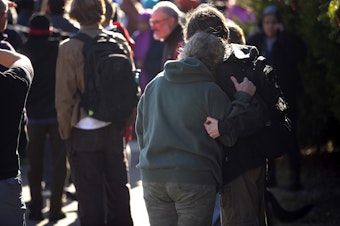 caption: Families reunite outside of Ingraham high school following a school shooting on Tuesday, November 8, 2022, in Seattle. 