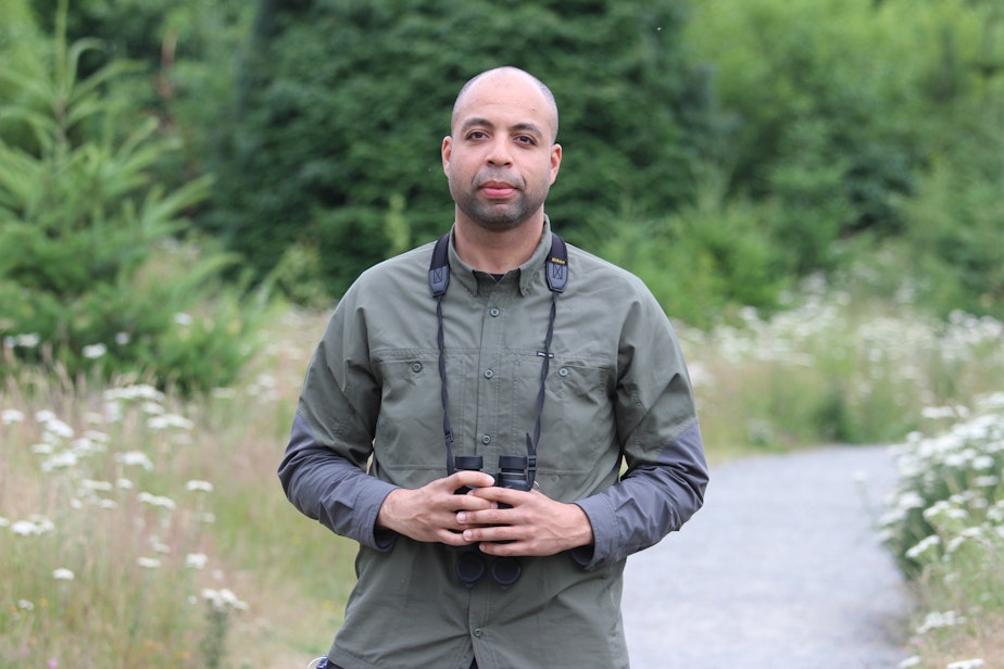 caption: Environmental scientist Armand Lucas on a birdwatching walk in Seattle's Discovery Park. 