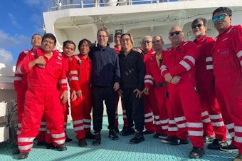 caption: Balthasar Wyss of Mercer Island, Washington, and Marcelo Osanai, of Brazil, after being rescued in the south Atlantic Ocean. Their rescuers were aboard the Front Pollux, an oil tanker.