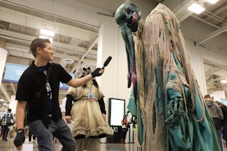 caption: KUOW's Dyer Oxley interviews Cthulu, a cosmic entity created by writer H. P. Lovecraft, at Emerald City Comic Con on Feb. 29, 2024.