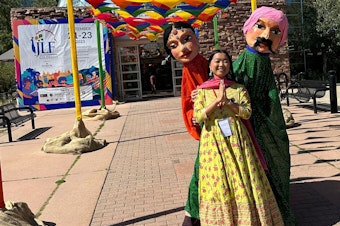 caption: A festivalgoer attends the Jaipur Literature Festival offshoot in Colorado in September 2023. JLF began in its titular city in 2006 and now has festivals around the world, which will include Seattle for the first time in 2024.