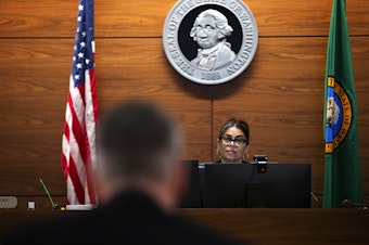 caption: Juvenile probation counselor Dan Baxter, left, speaks with Judge Veronica Galván in juvenile court, on Wednesday, August 14, 2024, at the Judge Patricia H. Clark Children and Family Justice Center in Seattle. 