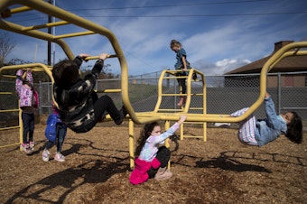 caption: Kindergarten students at Jackson Elementary play on a playground during recess on Tuesday, March 23, 2021, at the school along Federal Avenue in Everett. 