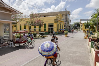 caption: People cycle along the street in Afuá, a city in northern Brazil's Pará state, in January. <strong></strong>Since 2002, this city on the banks of the Amazon River has been famously off limits to motor vehicles.