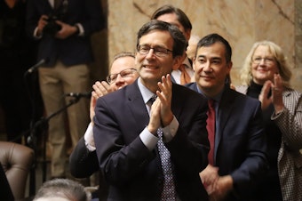 caption: Washington Attorney General — now governor-elect — Bob Ferguson is seen at the annual State of the State address in Olympia, Tuesday Jan. 9, 2024. As part of his budget priorities as governor, Ferguson says he will focus on reductions in state spending to help resolve a multi-billion dollar budget shortfall over the next several years.