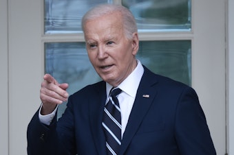 caption: President Biden walks to the Oval Office from the Rose Garden on May 14.