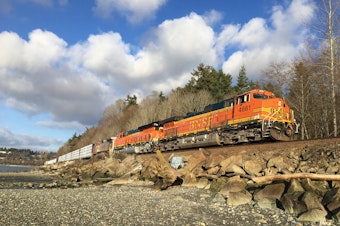 caption: A BNSF Railway freight train passes through Shoreline, Washington, in January 2021.