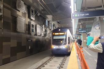 caption: The Sound Transit light rail is conducting final test runs inside the new U-District station.