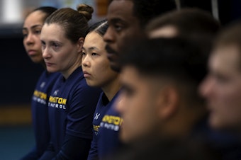 caption: Jisu Choi, 23, center, listens before a training exercise during State Trooper basic training on Thursday, July 11, 2024, at the Washington State Patrol Academy in Shelton. 