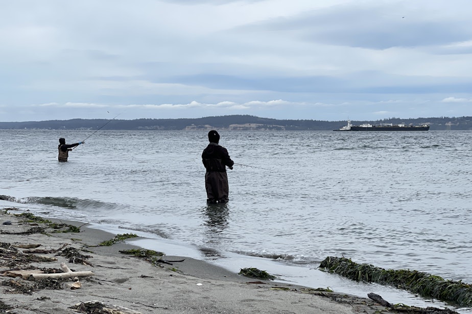 caption: Fishermen cast for coho salmon at Point No Point County Park on Puget Sound while a tank barge hauls petroleum products to the Seattle area on Sept. 28, 2024.