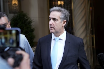 caption: Michael Cohen, former President Donald Trump's fixer, leaves his apartment building in New York this morning.