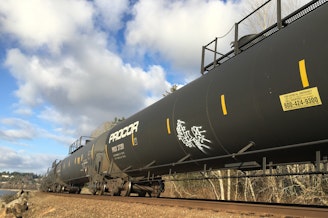 caption: A oil train heads south toward Seattle on Jan. 18, 2021, in Shoreline, Washington. 