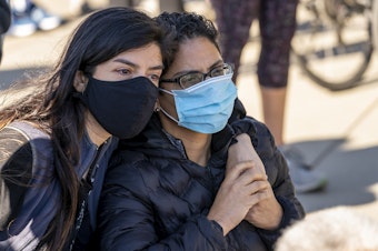 caption: As people gather at the Supreme Court on the day after the death of Justice Ruth Bader Ginsburg, Rosio Marin of Washington, left, comforts a close friend who declined to give her name, as they mourn the loss of one of the court's liberal justices, Saturday, Sept. 19, 2020 in Washington. 