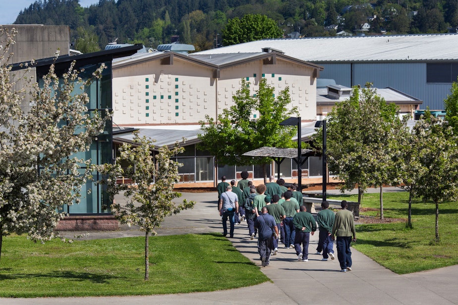 caption: Offenders are escorted across the campus at Green Hill School in Chehalis, Wash. on Wednesday, May 10, 2017. Green Hill is a medium/maximum security, fenced facility for teenage male offenders run by the State Department of Social and Health Services.