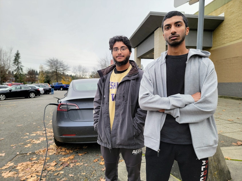 caption: Sophian and Moiz Mughal (right) drove from Sammamish to Kirkland to charge their Tesla on Thursday, November 21, 2024.