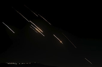 caption: Missiles launched from Iran towards Israel are seen in the West Bank city of Nablus Tuesday, Oct. 1, 2024. 