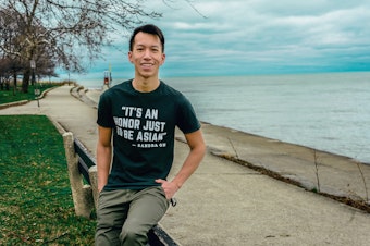 caption: Simon Tran sits for a portrait in Chicago, March 2021. 