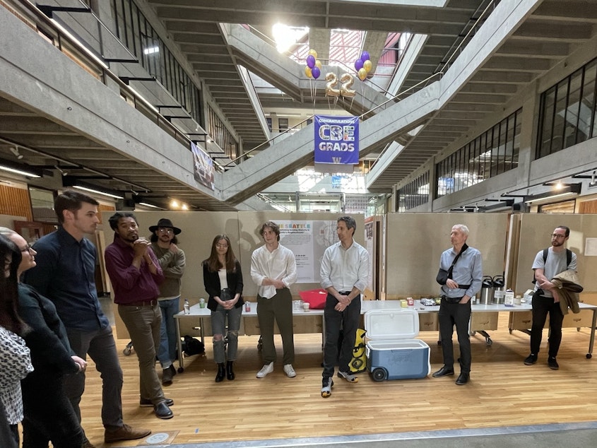 caption: Acting Director of Seattle's Office of Planning and Community Development Rico Quirindongo addresses graduating students and their instructors