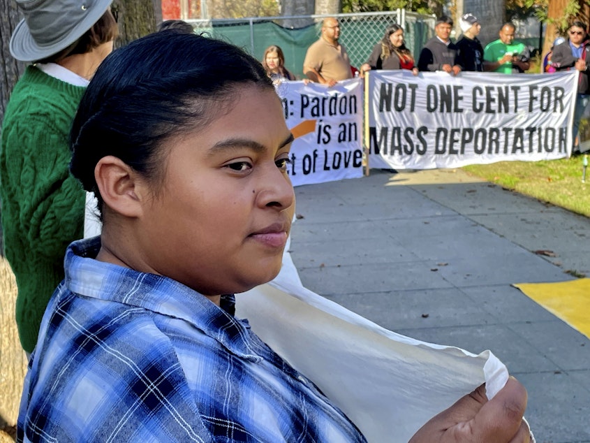 caption: Immigration advocates hold a rally in Sacramento, Calif. on Monday, Dec. 2, 2024, to protest President-Elect Donald Trump's plans to conduct mass deportation of immigrants without legal status.