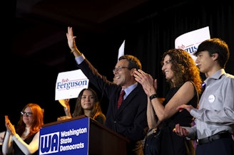 caption: Democratic governor candidate Bob Ferguson waves to supporters after speaking to a large crowd on Tuesday, November 5, 2024, during the Washington Democrats election night party at the Seattle Convention Center in Seattle. 