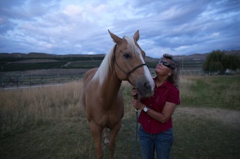 caption: Julie Hensley poses for a portrait with her horse, Hot Rod, at her home on Tuesday, July 16, 2019, in Brewster. 