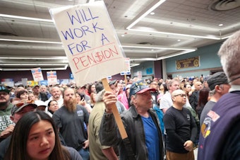 caption: Terry Muriekes, a tool-storage worker at Boeing's factory in Everett, Wash. for 38 years, holds a sign during a strike rally last week.

