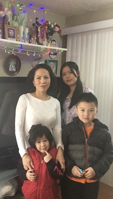 caption: RadioActive's Jennifer Nguyen (top right) poses with her mom, Michell, and her siblings.