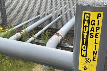 caption: Natural gas pipelines enter a building on the University of Washington campus in Seattle on May 19, 2023.