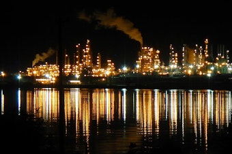 caption: Steam and invisible, heat-trapping carbon dioxide rise from the Tesoro, now Marathon Petroleum, oil refinery in Anacortes, Washington, in 2014.