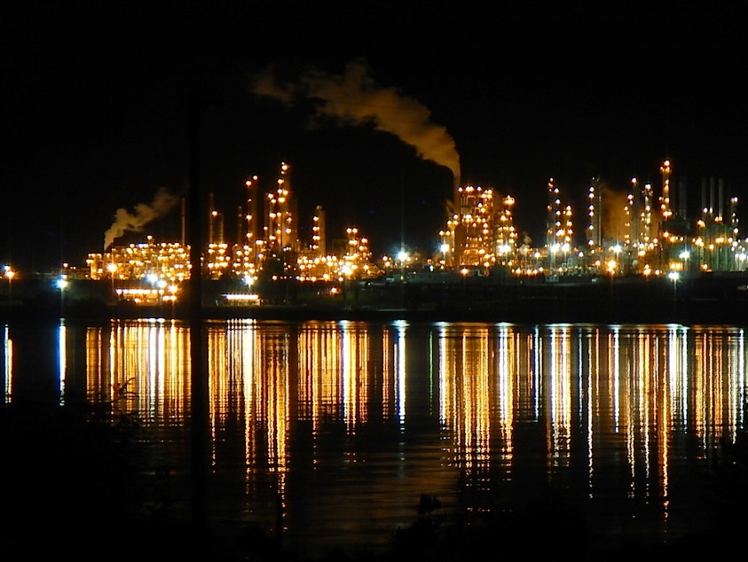 caption: Steam and invisible, heat-trapping carbon dioxide rise from the Tesoro, now Marathon Petroleum, oil refinery in Anacortes, Washington, in 2014.