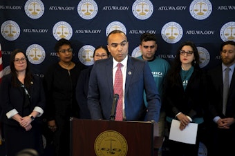 caption: Washington Attorney General Nick Brown addresses members of the press after filing a lawsuit against President Donald Trump’s executive order on birthright citizenship, on Tuesday, January 21, 2025, at the Attorney General’s Office in Seattle. 